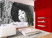 Wall Mural Jazz Singer - Black and white woman singing against the backdrop of a city 61118